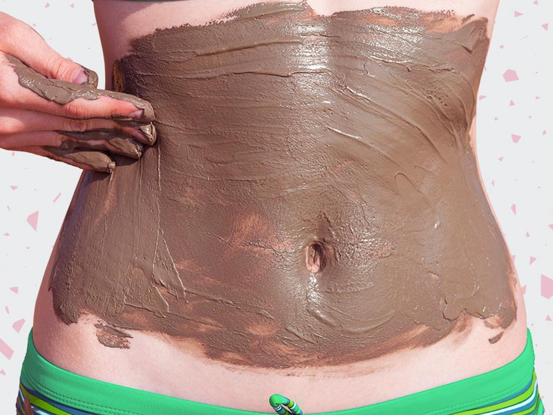 Mulher fazendo lipoescultura com gesso, passando argila bentonita na barriga