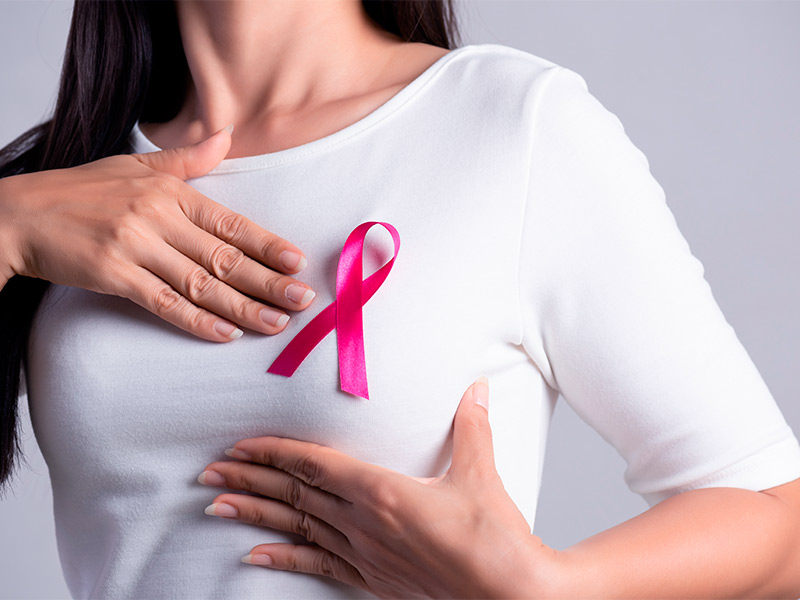 Mulher mostrando o símbolo do câncer na polimastia de mama